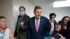 FILE - Senator Joe Manchin, a conservative Democrat representing the state of West Virginia, is surrounded by reporters at the Capitol in Washington, May 26, 2021. 
