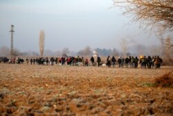 Migrants walk to reach Pazarakule border gate, Edirne, Turkey, at the Turkish-Greek border on March 1, 2020.