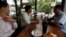 Men drink coffee and have breakfast at a coffee store in Phnom Penh, Cambodia July 19, 2018. (REUTERS/Samrang Pring)