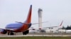 A Southwest Airlines jet waiting to depart in view of the air traffic control tower at Seattle-Tacoma International Airport, April 23, 2013. 