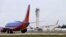 A Southwest Airlines jet waiting to depart in view of the air traffic control tower at Seattle-Tacoma International Airport, April 23, 2013. 