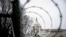 FILE PHOTO: Barbed wire and security fencing surrounds the U.S. Capitol in Washington, Jan. 26, 2021.