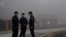 Security personnel stand guard near the Wuhan Institute of Virology after a World Health Organization team arrived for a field visit in Wuhan in China's Hubei province Wednesday, Feb. 3, 2021. The WHO team is investigating the origins of the…