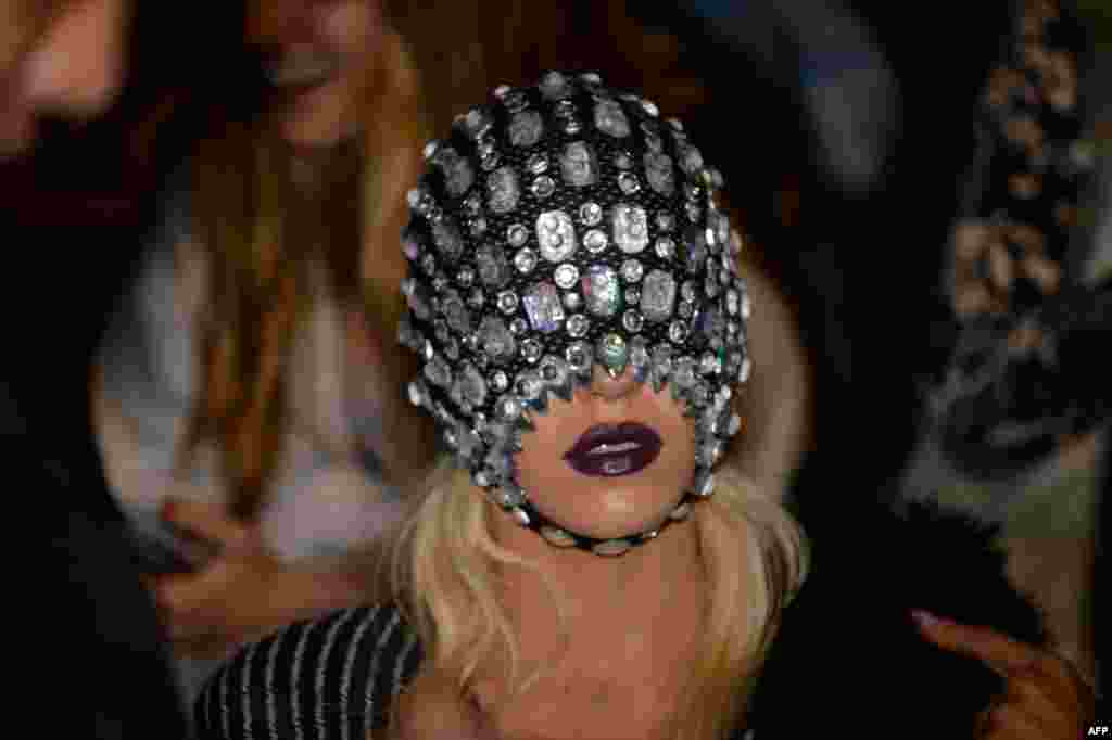A visitor watches the St. George NextGen show at Fashion Week in Sydney, Australia.
