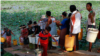 In this photo taken on April 21, 2012, local residents line up to fetch drinking water from a lake in Rangoon, Burma. (AP Photo)
