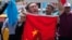 FILE - Uighurs living in Turkey and Turkish supporters, chant slogans before burning a Chinese flag, July 5, 2015. Since 2013, thousands of Uighurs, a Turkic-speaking Muslim minority from western China, have traveled to Syria to train and fight alongside al Qaida.