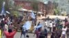 FILE - A still image taken from a video shot on Oct. 1, 2017, shows protesters waving Ambazonian flags in front of a road block in the English-speaking city of Bamenda, Cameroon. 