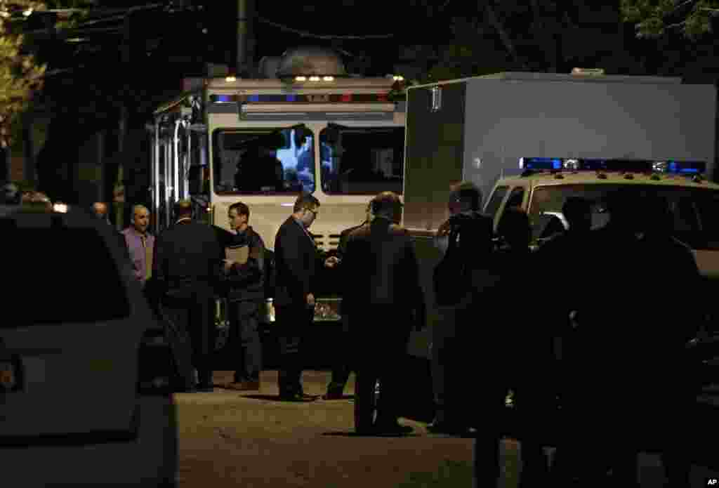 Police and FBI congregate outside a house where three missing women were found, Cleveland, Ohio, May 6, 2013.