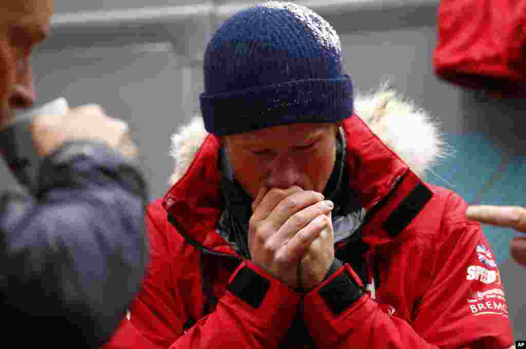 Britain&#39;s Prince Harry warms his hands after a cold chamber training exercise with the Walking with the Wounded South Pole Allied Challenge 2013 British team at Nuneaton, central England. Prince Harry joined the team inside the whole-vehicle environmental test chambers which simulate the extreme conditions they will face in the South Pole.