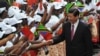 Chinese President Xi Jinping (R) shakes hand with traditional dancers upon his arrival at Julius Nyerere International airport in Dar es Salaam, Tanzania, March 24, 2013.