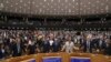 MEP's sing and hold hands after a vote on the UK's withdrawal from the EU, the final legislative step in the Brexit proceedings, during the plenary session at the European Parliament in Brussels, Jan. 29, 2020. 