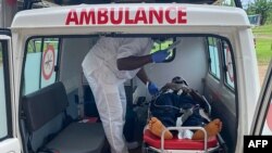 FILE - A handout photo from Medecins Sans Frontieres (Doctors Without Borders) on Oct. 25, 2020, shows a medic treating a victim of a shooting at a bilingual school in Kumba, Cameroon, the day before.