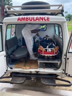 FILE - A handout photo from Medecins Sans Frontieres (Doctors Without Borders) on Oct. 25, 2020, shows a medic treating a victim of a shooting at a bilingual school in Kumba, Cameroon, the day before.