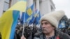 FILE - Anti-Yanukovych protesters take part in a rally outside the parliament building in Kyiv, Ukraine, Feb. 27, 2014.