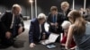 U.S. Secretary of State John Kerry (2nd L), U.S. Under Secretary for Political Affairs Wendy Sherman (2nd R) and staff watch a tablet in Lausanne as U.S. President Barack Obama makes a state address on the status of the Iran nuclear program talks, April 2