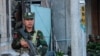 This photo taken on November 9, 2023 shows a fighter of the ethnic armed group Ta'ang National Liberation Army (TNLA) standing guard in the town of Namhkam in northern Shan state.
