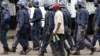 Zimbabwean police arrest an MDC supporter in Harare recently … Activists say ongoing political unrest in Zimbabwe makes it dangerous for migrants in South Africa to return to their homeland