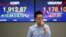 A currency trader walks by the screens showing the Korea Composite Stock Price Index (KOSPI), left, and the foreign exchange rate between U.S. Dollar and South Korean Won at the foreign exchange dealing room in Seoul, South Korea, June 24, 2016. 