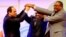 FILE - Sudanese President Omar al-Bashir, center, Egyptian President Abdel-Fattah el-Sissi, left, and Ethiopian Prime Minister Hailemariam Desalegn, right, hold hands after signing an agreement on sharing water from the Nile River, in Khartoum, Sudan, Mar