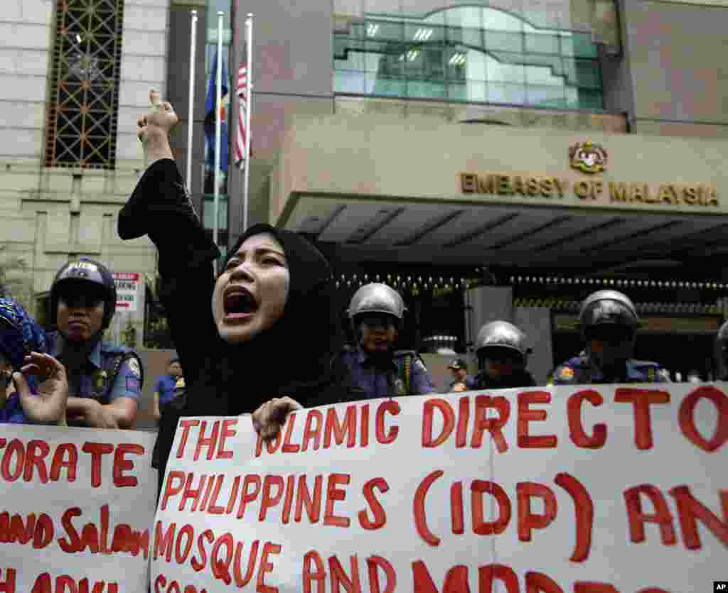 Demonstran Filipina meneriakkan slogan-slogan anti kekerasan yang dilakukan pasukan Malaysia di Kalimantan dalam demonstrasi di Kedutaan Besar Malaysia di Manila (5/3). (AP/Bullit Marquez)