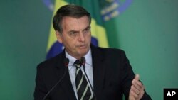 Brazil's President Jair Bolsonaro speaks during a ceremony where he signed a decree loosening restrictions on owning a firearm at Planalto presidential palace in Brasilia, Brazil, Tuesday, Jan. 15, 2019. 