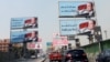 FILE - Cars move along the '6th October Bridge' lined with banners of Egyptian President Abdel Fattah el-Sissi, in Cairo, Egypt, Oct. 2, 2019.