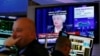 Traders work as Federal Reserve Chair Janet Yellen speaks on a television above the floor of the New York Stock Exchange (NYSE) shortly after the opening bell in New York City, June 15, 2016