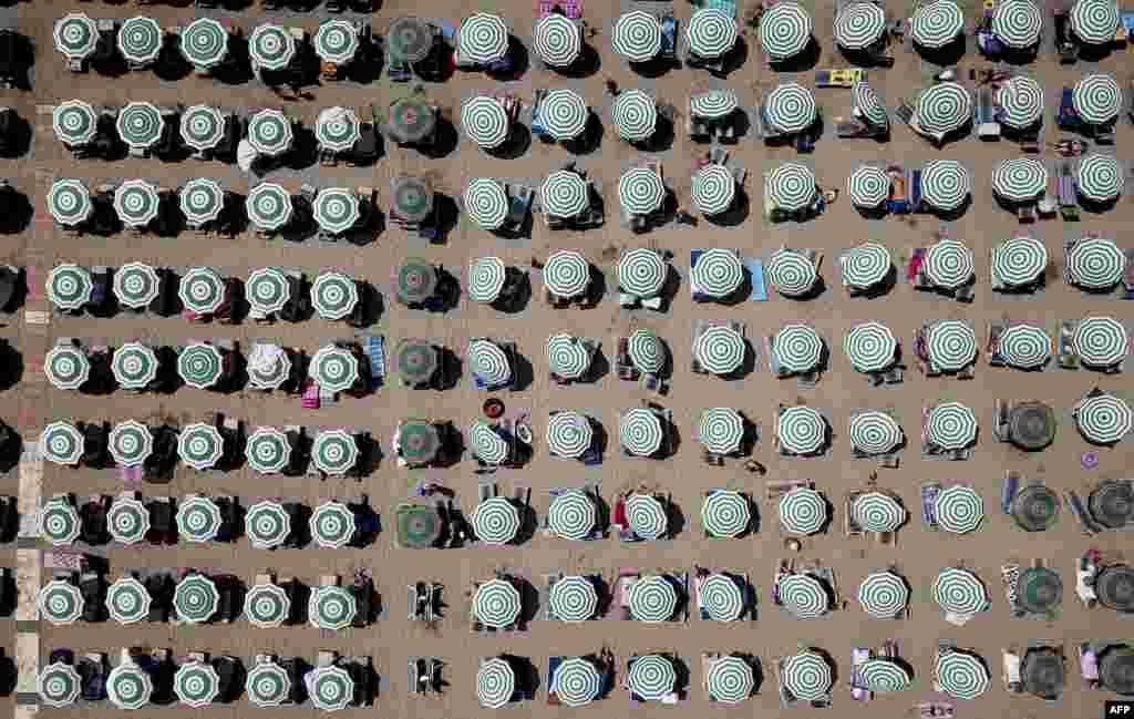 This aerial photograph shows parasols on a beach of the Adriatic Sea in Durres, as a heatwave sweeps across Europe.