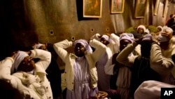 来自尼日利亚的基督徒朝圣者圣诞前夜在伯利恒圣诞教堂内的圣诞洞里祷告。传统上认为耶稣诞生在这里。（2014年12月24日）