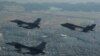 2017년 12월 주한미군 군산기지에 배치된 F-16 전투기들(왼쪽)과 미 유타주 힐 공군기지에서 전개한 F-35A 전투기가 군산 상공을 함께 비행하고 있다.