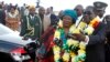 Zimbabwe's President Robert Mugabe, right, welcomes Malawian counterpart Joyce Banda upon her arrival at Harare International Airport, April 23, 2013.