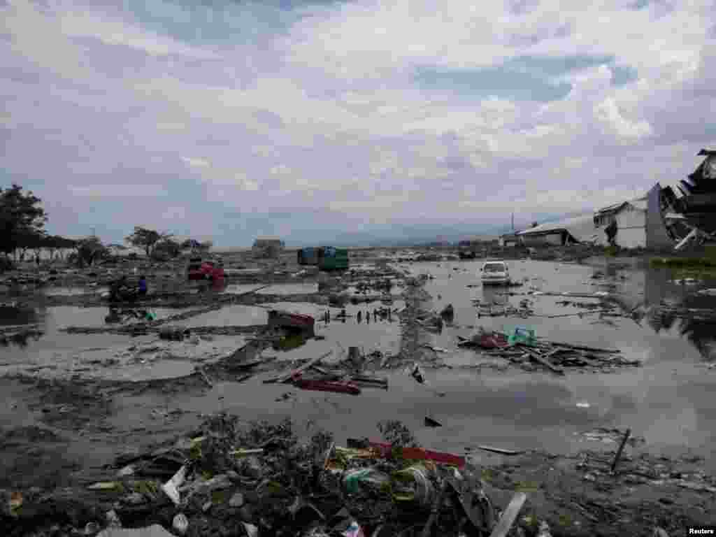 The ruins of cars are seen after a tsunami hit in Palu, Indonesia, Sept. 29, 2018.