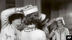 Archive image of pioneering French fashion designer Coco Chanel (left) with actress Romy Schneider in Paris, France, in 1960.
