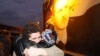 FILE - A freed Syrian prisoner, left, hugs his brother after being released from Adra Prison on the northeast outskirts of Damascus, Syria, on Jan. 16, 2012. 