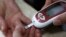A patient takes a blood glucose test during an event aimed to help people with diabetes to cope with their illness at Saint Luka diagnostics medical center in Sofia, November 13, 2012. Picture taken November 13, 2012. REUTERS/Stoyan Nenov (BULGARIA - 