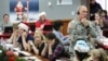 FILE - NORAD and U.S. Northern Command Chief of Staff Maj. Gen. Charles Luckey joins other volunteers taking phone calls from children around the world asking where Santa is, at Peterson Air Force Base, Colo., Dec. 24, 2014.