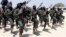 FILE - Hundreds of newly trained al-Shabab fighters perform military exercises in the Lafofe area, south of Mogadishu, Somalia, Feb. 17, 2017. 