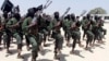 FILE - Hundreds of newly trained al-Shabab fighters perform military exercises in the Lafofe area 18 km south of Mogadishu, Somalia, Feb. 17, 2017. 