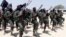 FILE - Hundreds of newly trained al-Shabab fighters perform military exercises in the Lafofe area 18 km south of Mogadishu, Somalia, Feb. 17, 2017. 