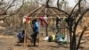 FILE - Two South Sudanese brothers build a hut at the Imvempi settlement in Arua district, Uganda, Jan. 30, 2018. (H. Athumani/VOA)