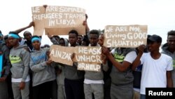 FILE - Migrants are seen at a detention center in Tripoli, Libya, April 4, 2019. 