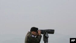 FILE - A South Korean army soldier watches the North Korea side from the Unification Observation Post in Paju, South Korea, near the border with North Korea, Dec. 25, 2019. 