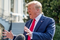 President Donald Trump speaks to members of the media on the South Lawn of the White House in Washington, Aug. 7, 2019.