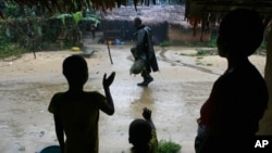FILE - Locals wave good-bye to a departing Nigerian soldier in Archibong in the southern Bakassi Peninsula, in this Aug. 14, 2006, photo, as Nigerian troops withdrew from the disputed area, which was officially handed over to Cameroon in 2008.