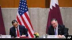 Secretary of State Mike Pompeo, right, and Qatar's Deputy Prime Minister Mohammed bin Abdulrahman Al Thani sign a memorandum of understanding during the third annual U.S.-Qatar Strategic Dialogue at the State Department, Sept. 14, 2020 in Washington. 