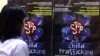 FILE - A Filipino girl looks at posters condemning child trafficking inside a shelter for runaway child laborers in Manila.