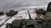 In this photo taken from video released by the Russian Defense Ministry Press Service on Feb. 2, 2022, Russian and Belarusian tanks drive during joint military drills at Brestsky firing range, Belarus.