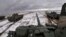 In this photo taken from video released by the Russian Defense Ministry Press Service on Feb. 2, 2022, Russian and Belarusian tanks drive during joint military drills at Brestsky firing range, Belarus.