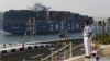 FILE - In this Thursday, Aug. 6, 2015, file photo, a cargo container ship crosses the new section of the Suez Canal after the opening ceremony in Ismailia, Egypt. In a few short years, if everything goes according to plan, Egypt will have new megaprojects, special investment zones and power plants fueled by the largest offshore gas field in the Mediterranean. But in the more immediate future, experts say the government needs to boost investment and bring in foreign capital to avoid a looming cash crunch. (AP Photo/Hassan Ammar)