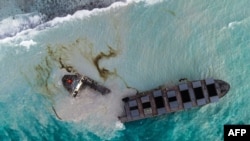 This aerial picture shows the MV Wakashio bulk carrier that had run aground and near Blue Bay Marine Park, Mauritius, splits into two.